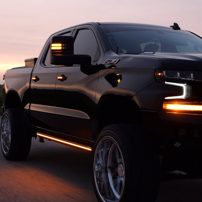 Black 2019+ Chevy Silverado 1500 with boost auto mirrors, door handles and M2 running boards lit up in amber