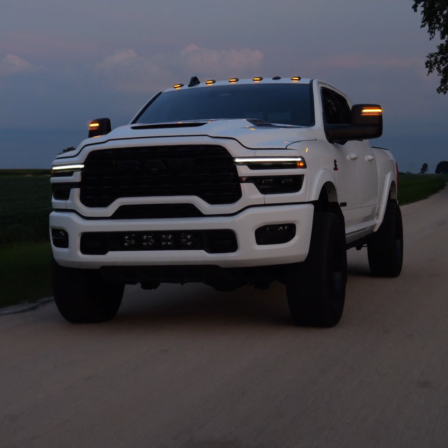 A roller picture of the cab lights with Amber LED on a 2025 RAM 2500/3500 driving on the road
