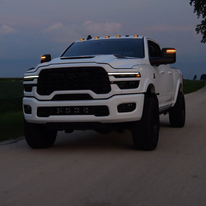 A roller picture of the cab lights with Amber LED on a 2025 RAM 2500/3500 driving on the road