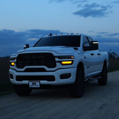 A roller picture of the cab lights with White LED on a 2025 RAM 2500/3500 driving on the road